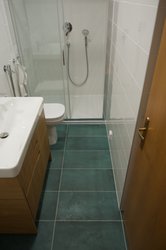 Malá koupelna s obklady BLANCO BRILLO a designovou dlažbou LEMMY