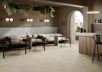 Dlažba v imitaci kamene Atlantis sabbia a perla béžová a šedá barva v komerčním prostoru restaurace na podlaze a na stěně