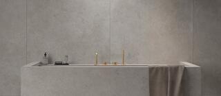 Velkoformátová šedá dlažba Elysian EY04 Gris Catalan na podlaze i stěně v koupelně